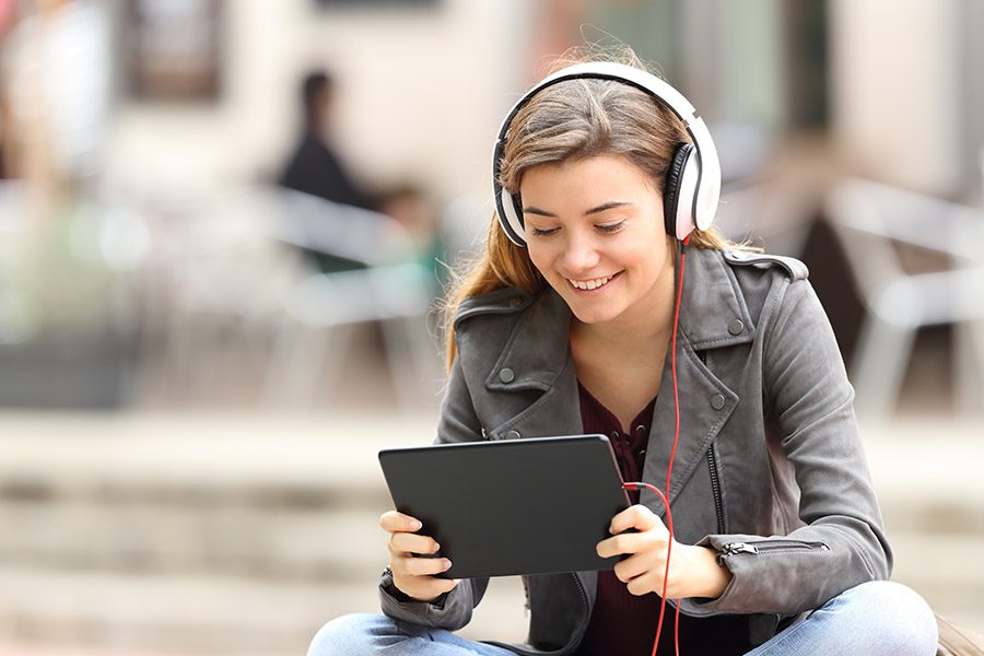 Video Library - Girl Learning On Line with a Tablet and Headphones